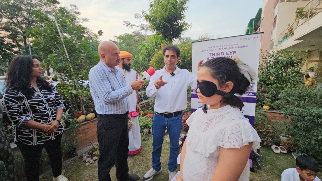 Chanderkant Harsh speaking during an outdoor workshop event